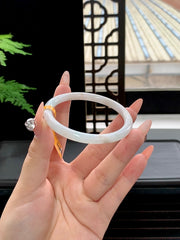 Finished bangle with gold-flecked inclusions