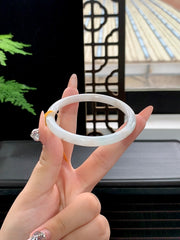 Finished bangle with gold-flecked inclusions