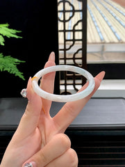 Finished bangle with gold-flecked inclusions