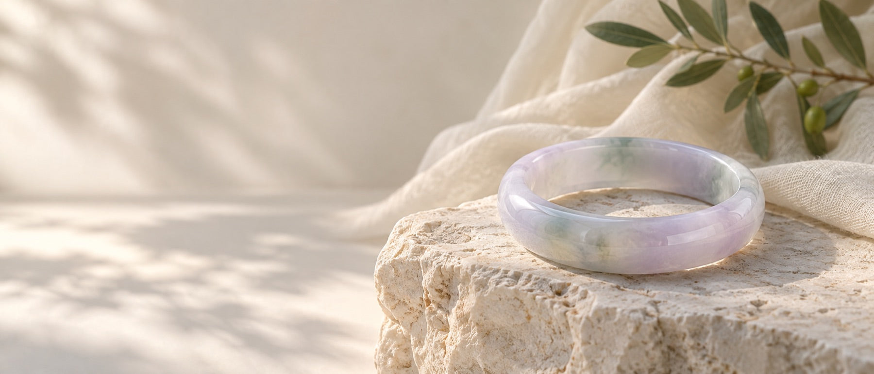 Lavender-white natural jadeite bangle on stone